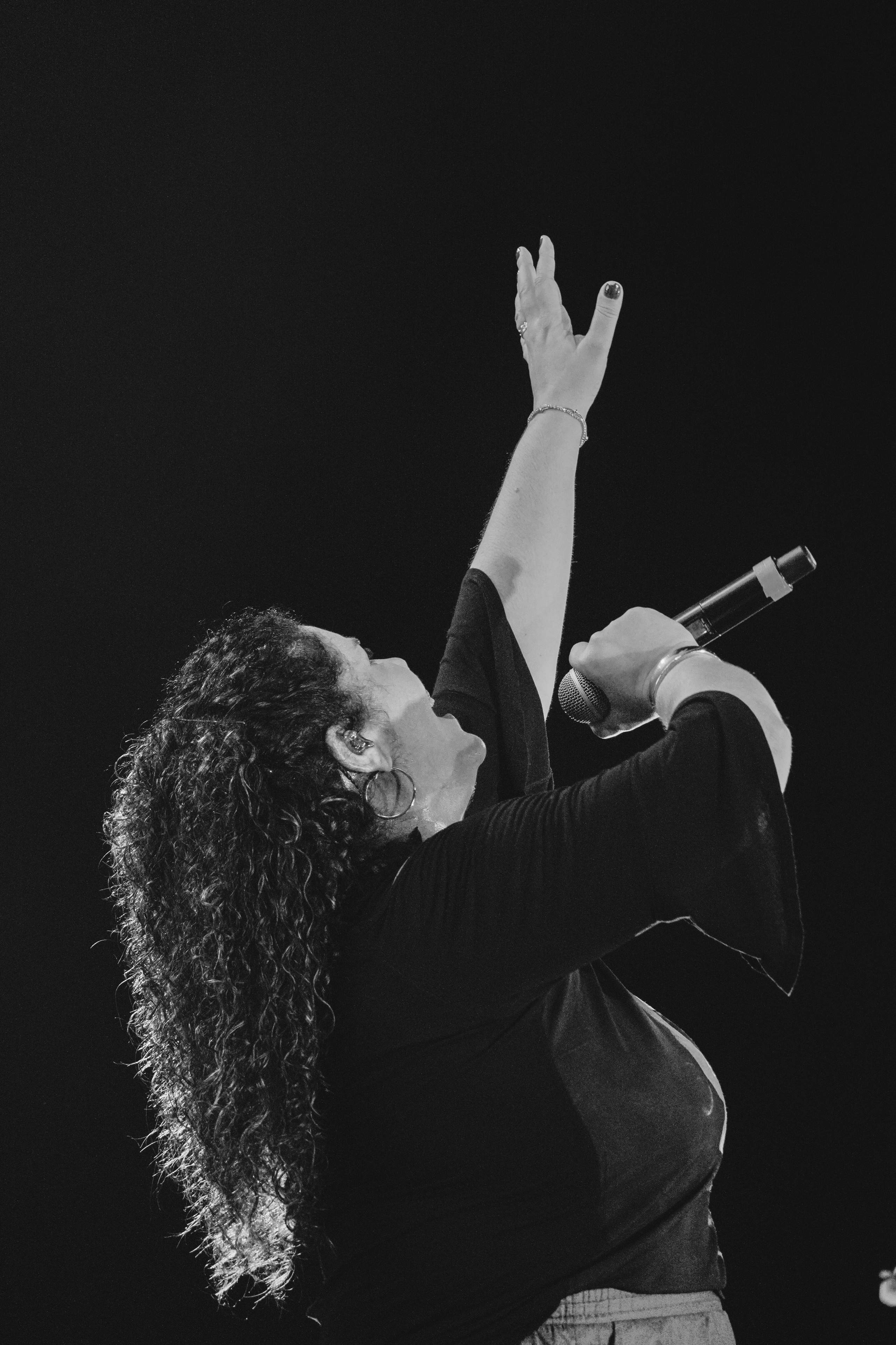 Cantora Eliana Ribeiro em silhueta durante apresentação artística no Consagra-te da arquidiocese de Natal à São Miguel Arcanjo