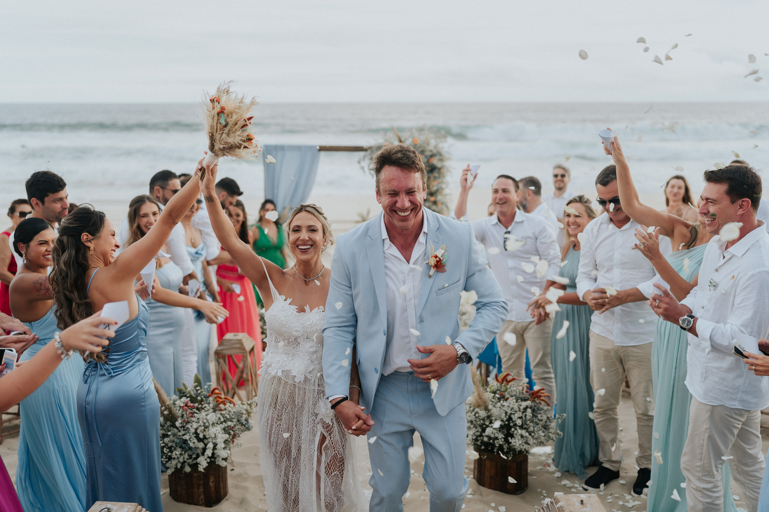 Wedding couple celebrating on the beach, romantic destination wedding in Rio de Janeiro, Brazil wedding photography.