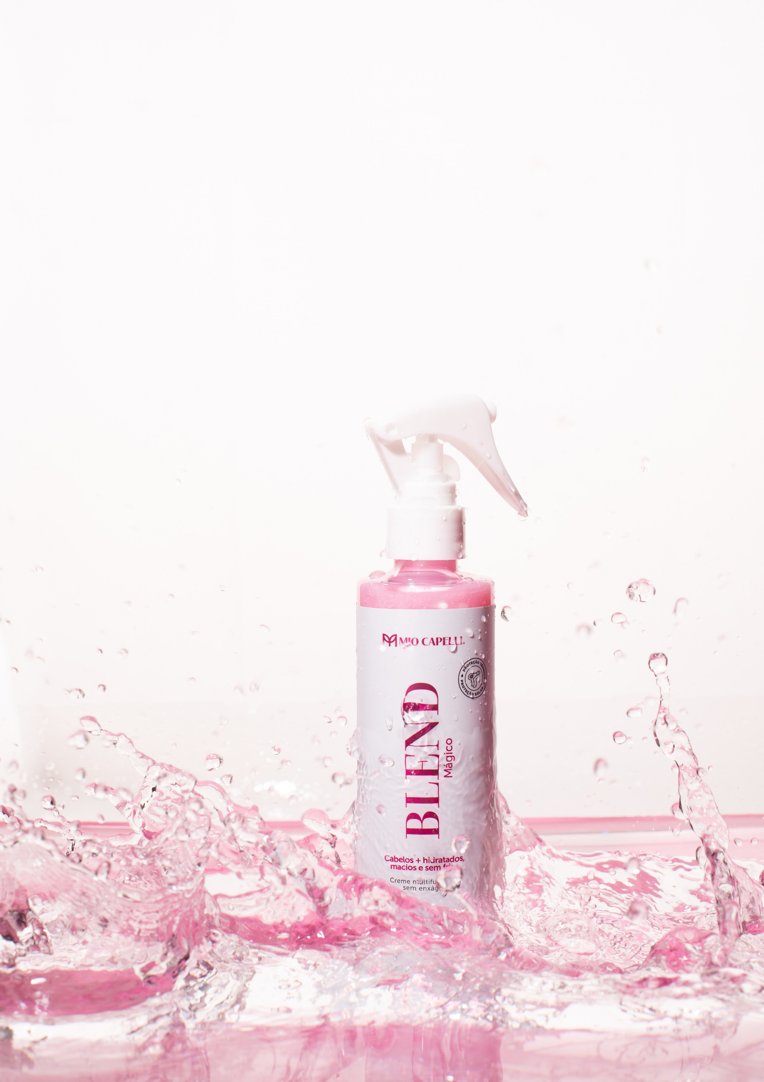 Creative still photo of spray for hairs on the water, ready for application. Product with water splashes for freshness effect. 