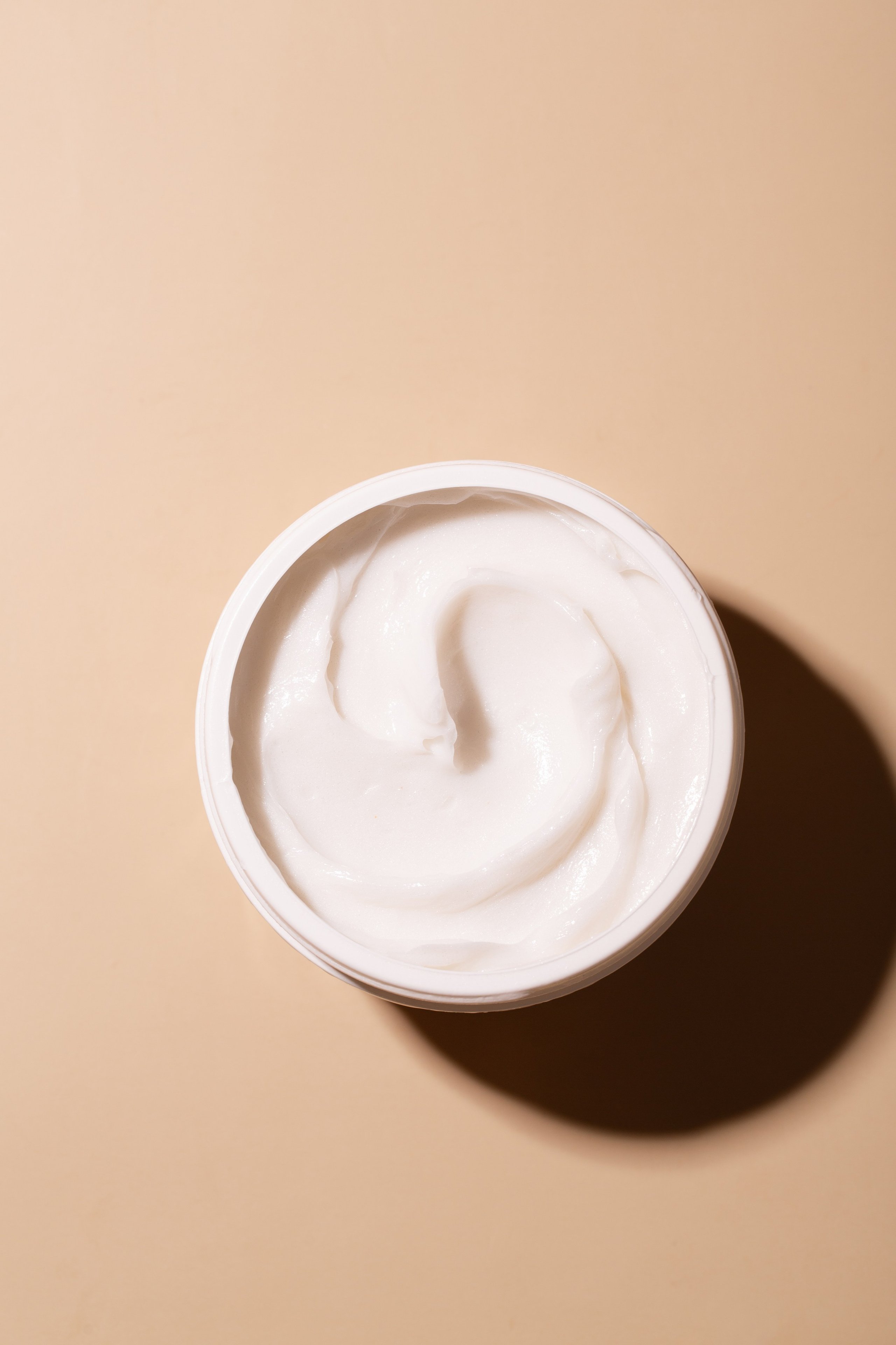 Rich, creamy hair mask with smooth texture, ready for application. Close-up profession photo. 