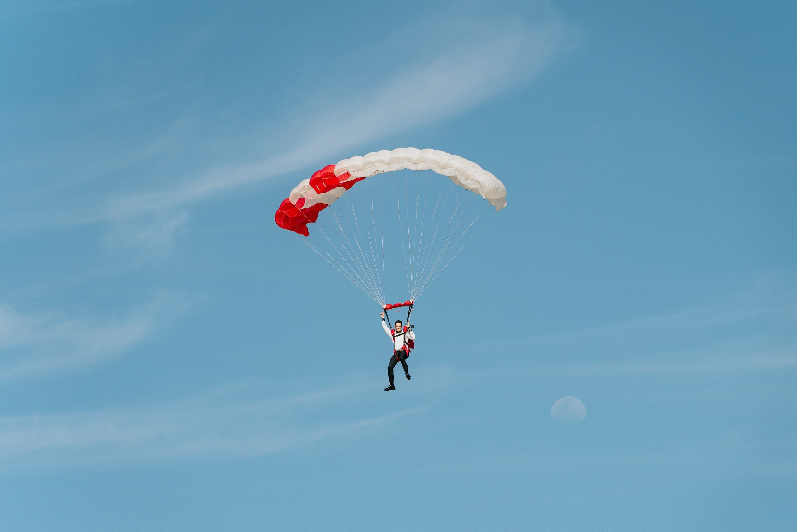 Groom skydiving in Rio de Janeiro during adventurous destination wedding in Brazil.